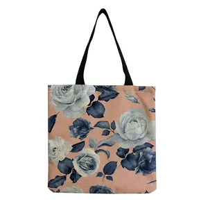 Close-up detail of a large capacity pink tote bag featuring blue rose floral patterns