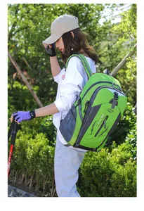 Model wearing a large green outdoor hiking backpack in a natural garden setting outdoors