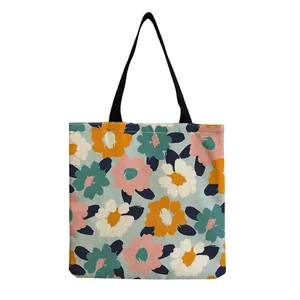Detailed view of a large capacity floral print tote bag with vibrant flowers and black straps