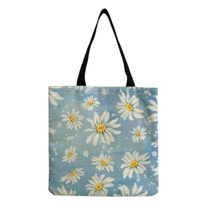 Close-up of lightweight daisy print linen tote bag featuring durable black shoulder straps