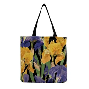 Large floral print tote bag featuring yellow and purple iris patterns on a black background