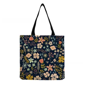 Macro detail of colorful floral patterns on a navy blue canvas shopping tote bag.