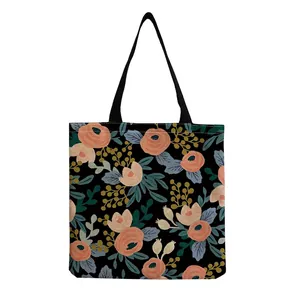 Detailed view of the vibrant floral print and woven texture on a black tote bag
