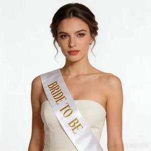 Detail of white satin sash with gold Bride to be lettering for bridal party