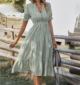 Detail view of green and white striped V-neck summer dress with elastic waist.