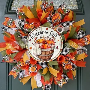 Autumn harvest wreath detail featuring Welcome Fall sign with maple leaf and pumpkin ribbons