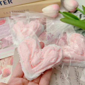 Detail view of heart-shaped butter-spread squeeze toy with pearl bead accents