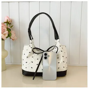 Korean style textured handbag with black bow patterns and smartphone size reference