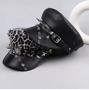 Detailed view of punk style leather hats with long silver spikes and leopard print texture.