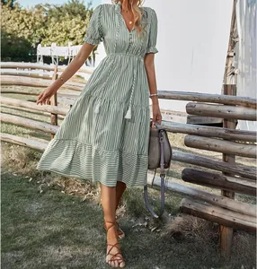 Green and white striped V-neck midi dress with elastic waist in an outdoor garden