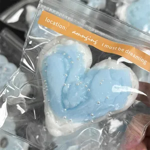 Detail of heart-shaped butter slime squeeze toy with pearl beads in packaging