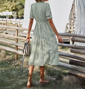 Detail back view of a green striped short sleeve midi dress with an elastic waist