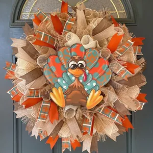 Detail view of Thanksgiving turkey wreath with festive orange and brown mesh ribbons