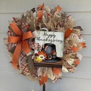 Detailed view of autumn Thanksgiving wreath with mesh, ribbons and pilgrim hat wooden sign.