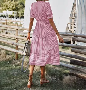 Detailed back view of a pink striped tiered dress with ruffle sleeves and waist.