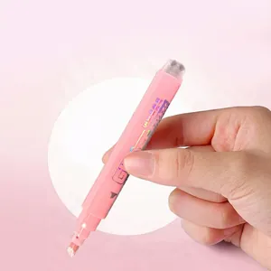 Macro view of a 122mm pink glitter highlighter pen held by a hand for scale reference
