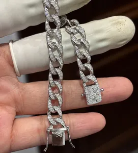 Detail view of a 925 sterling silver iced out Cuban link bracelet with Moissanite