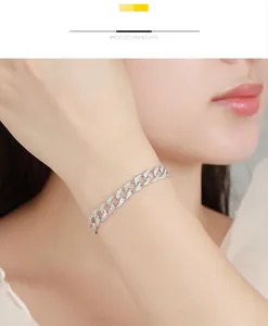 Close-up of a 925 sterling silver Moissanite Cuban chain bracelet worn on a wrist