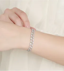 Close-up of 925 sterling silver Cuban link bracelet with sparkling moissanite diamonds.