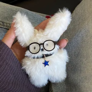 Close-up of a cute white fluffy bunny plush keychain wearing black round glasses