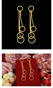Elegant long tassel earrings featuring multiple gold rings and delicate snake chains.