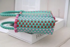 Detailed view of the vibrant hand-woven texture on a plastic tote bag