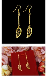 Elegant long leaf-shaped drop earrings in polished gold finish, stylish jewelry accessory