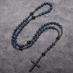 Detailed view of religious rosary necklace with beads and black cross pendant