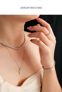 Detail macro view of elegant moissanite tennis necklace and bracelet set on a model