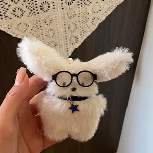 Cute white long-haired plush puppy keychain featuring glasses and a blue star pendant