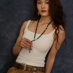 Asian model wearing long wooden bead rosary necklace with hematite cross pendant