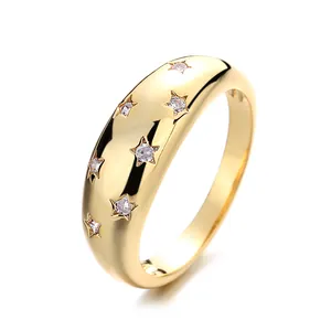Elegant minimalist gold-colored band ring featuring star engravings with sparkling crystals