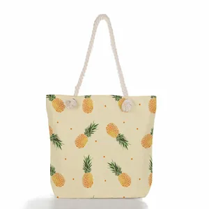 Detailed front view of women's beach tote bag with pineapple print and rope handles