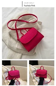Detailed view of fuchsia snakeskin texture on a trendy small square felt handbag