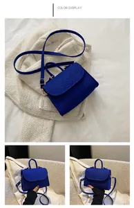 Vibrant royal blue snake pattern handbag featuring a top handle and adjustable crossbody strap