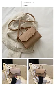 Detailed view of khaki snake-pattern handbag with top handle and crossbody strap
