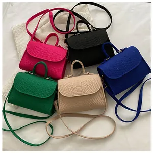 Detailed view of fashionable snake-pattern small square crossbody bags in vibrant candy colors