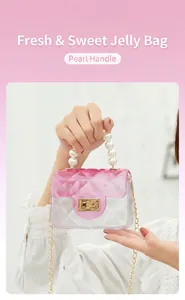Close-up detail of mini pink gradient jelly bag featuring pearl handle and golden chain