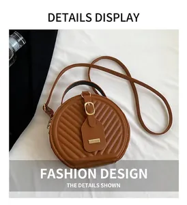 Detailed view of a stylish brown quilted round crossbody bag with gold buckle hardware