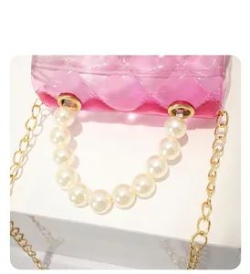 Detailed view showing the elegant pearl handle and pink gradient quilted jelly bag texture
