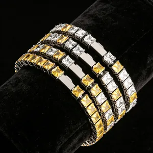 Macro view of four stainless steel tennis bracelets with yellow and clear cubic zirconia stones.