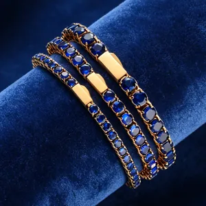 Close-up of three blue zircon tennis bracelets on a navy velvet display stand