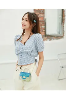 Asian model wearing a mini gradient jelly bag with pearl handle and golden chain strap