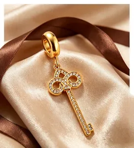 Detailed close-up of a luxury golden key pendant set with shimmering cubic zirconia stones