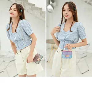 Fashion model wearing a mini gradient jelly bag with pearl handle and gold chain strap