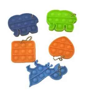 Close-up of various colorful silicone pop it fidget toy keychains for stress relief.