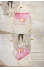 Close-up of mini pink gradient transparent jelly bag with pearl handle and gold chain