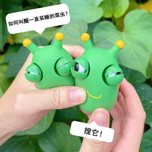 Close-up of green cabbage worm squeeze toy with pop-out eyes for stress relief.