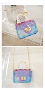 Close-up view of a mini gradient jelly handbag featuring pearl handle and golden chain