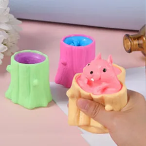 Close-up of cute pink squirrel popping out of a tan tree stump squeeze toy